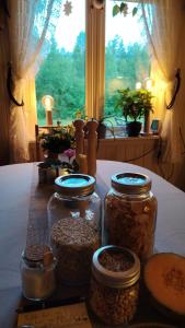a table with three jars of food and a window at Landgård Feriehus, Trysil sentrum, only a 5 minutes drive in Trysil