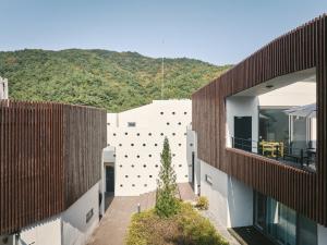 an external view of a building with a mountain in the background at Seosan Soohwarim in Okkye-ri