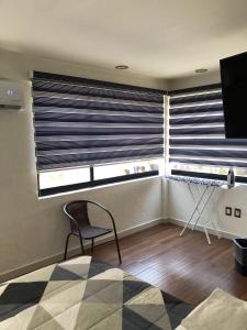 Zimmer mit einem Stuhl und einem Fenster mit Jalousien in der Unterkunft Casa Mireles in Oaxaca de Juárez + 20 Fotos