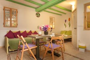 a dining room with a table and chairs and a couch at Studio with garden in Rovinj in Rovinj