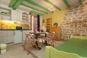 a kitchen and dining room with a table and chairs at Studio with garden in Rovinj in Rovinj