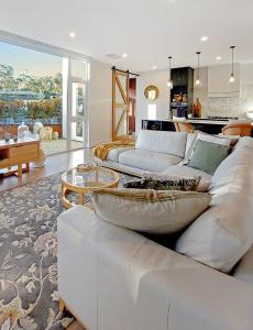 a living room with a white couch and a table at Magnolia - Your Private Luxury Escape Awaits in Scamander