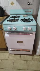 a white stove with a blue top in a kitchen at Casa los Abuelos in Malargüe