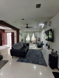 a living room with a couch and a rug at Ujana Kingfisher double storey 3 Bedroom - Farah Biz Homestay in Kota Kinabalu