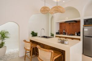 a kitchen with a large island with a counter top at MarenaSol Villa Bingin, 1 BR Luxury Private Villa in Uluwatu