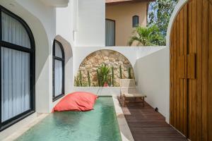 a swimming pool in the middle of a house at MarenaSol Villa Bingin, 1 BR Luxury Private Villa in Uluwatu