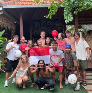 a group of people posing for a picture at Naughty Nest Hostel Bali in Canggu