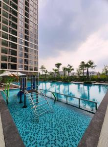 a swimming pool with a slide in front of a building at TC1 Canopy Luxhome Smart City in Phú Thú