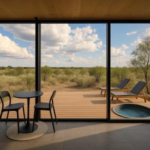 a room with a view of a deck with a table and chairs at Ursa Major at The Retreat in Fredericksburg