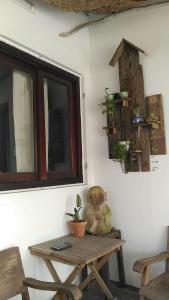 a teddy bear sitting on a table next to a window at La Sen-Thu An-Có cửa sổ nhìn ra ban công in Thôn An Hòa +7 photos