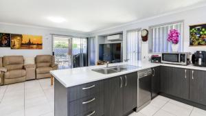 a kitchen with a sink and a counter top at The Eel Place Retreat in Bongaree