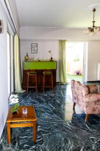 a living room with a green table and a couch at Ρετιρέ με θέα in Athens