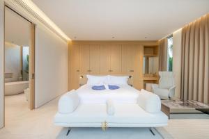 a bedroom with a white bed and a bathroom at Asherah Villa By Asherah Team in Ban Phru Champa +167 photos