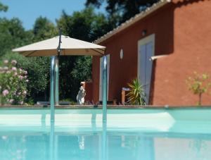una sombrilla sentada junto a una piscina en Soleil Rouge, en Les Adrets-de-l'Estérel