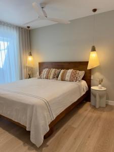 a bedroom with a large bed and two lamps at A beautiful Noosa Gem in Sunrise Beach in Sunrise Beach +21 photos