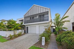 a large white house with a garage at Serenity on Seaside - Kingscliff in Kingscliff