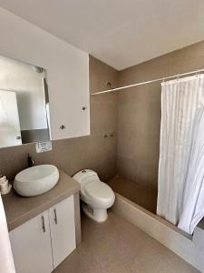 a bathroom with a toilet and a sink and a shower at Casa Bahía El Ñuro in El Ñuro