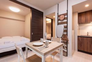 una habitación con una cama, una mesa y sillas en Hostel Inn Tokyo Asakusa Annex, en Tokio