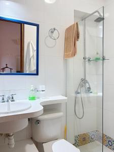 a bathroom with a shower and a toilet and a sink at Casa Digna in Cartagena de Indias