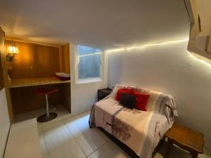 a bedroom with a bed with red pillows on it at OYO 94764 Syariah KamarGue in Jakarta