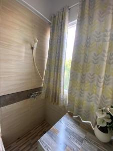 a bathroom with a shower curtain and a window at OYO 94764 Syariah KamarGue in Jakarta +19 photos
