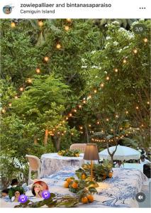 a table with fruits and vegetables on it with lights at Bintana Sa Paraiso in Mambajao