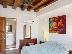 a bedroom with a bed and a painting on the wall at Casa Digna in Cartagena de Indias +53 photos