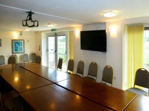 a conference room with a large wooden table and chairs at The Peacock Country Inn in Chinnor