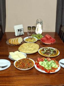 a wooden table with plates of food on it at Guest House koshki in Iprari +20 photos