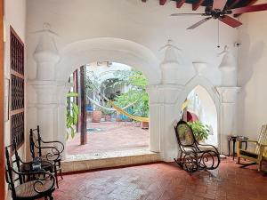 an archway in a room with chairs and a playground at Casa Digna in Cartagena de Indias