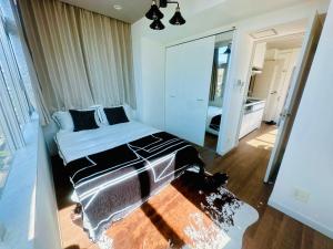 a bedroom with a bed and a large mirror at Miyazaki in Tokyo