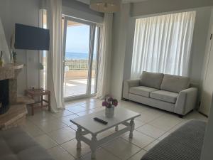 a living room with a couch and a coffee table at OLIVE&VIEW in Nea Moudania