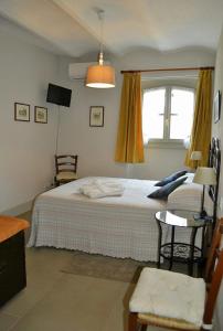 a bedroom with a large bed and a window at Agriturismo Fiamberta in Certosa di Pavia