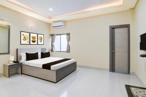 a bedroom with a bed and a television in it at Super Collection O Joka Industrial Plaza in Kolkata