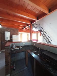 a kitchen with a sink and a staircase at El Descanso in Roldán +11 photos