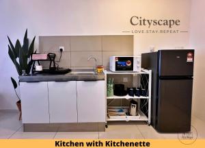 a kitchen with a sink and a refrigerator at Majestic Residence Kuala Lumpur by Cityscape in Kuala Lumpur