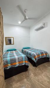 a bedroom with two beds in a room at D'Villa Roomstay in Tangkak