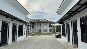 a house with a car parked between two buildings at D'Villa Roomstay in Tangkak