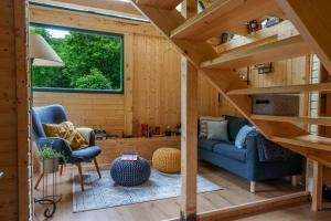 a tiny house with a staircase and a living room at Mountain Retreat Stars Peak in Bačić Duliba