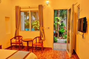 a bedroom with a bed and a table and chairs at S79 Blue in Phu Quoc