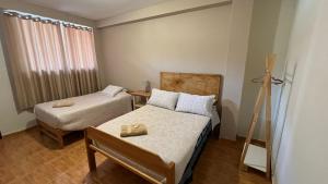 Ένα ή περισσότερα κρεβάτια σε δωμάτιο στο Casa Paqocha - Ollantaytambo Private Rooms - Wifi - Cocina Compartida