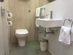 a bathroom with a white toilet and a sink at Irvine Bay in Irvine