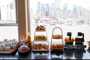 a table with different types of pastries and drinks at Salita Hotel Phnom Penh in Phnom Penh