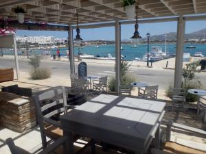 a table and chairs on a patio with a view of the ocean at Hotel Mantalena in Antiparos Town