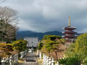 a view of a cemetery with a pagoda and a building at Morita-ya Japanese style inn KingyoーVacation STAY 62437 in Tamana