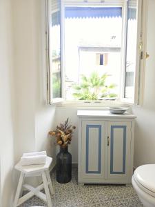a bathroom with a toilet and a window at Casa Longhi in Orta San Giulio +62 photos
