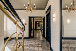 a hallway with a staircase and a chandelier at Azure Palace - LoftAffair Collection in Kraków +64 photos
