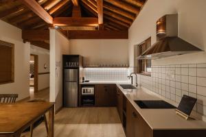 a large kitchen with wooden ceilings and wooden counters at Luxury Hanok Garden Retreat in Incheon