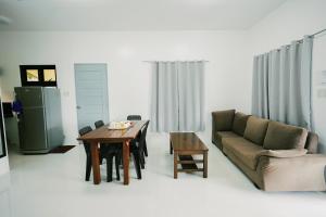 a living room with a table and a couch at Ginadel Agritourism Park in Sampong