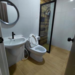 a bathroom with a toilet and a sink and a mirror at Baanjaifu บ้านใจฟู in Ban Muang Ba +36 photos